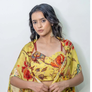 A yellow floral printed blouse paired with a neon green printed drape set, showcasing vibrant colors and elegant design.jpg