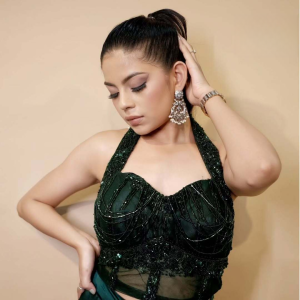an emerald green halter dress, showcasing a stylish drape set, exuding elegance and sophistication.jpg