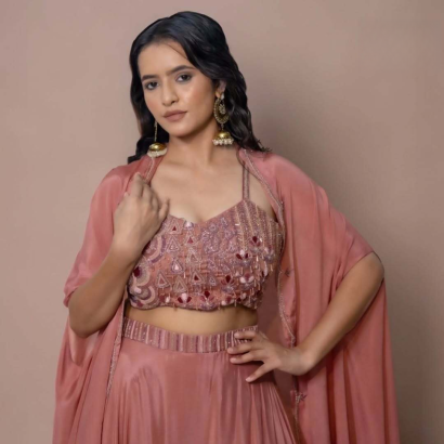 Pink embroidered lehenga set with sequin work, complemented by a sequin blouse and a brick brown lehenga with a cap.jpg